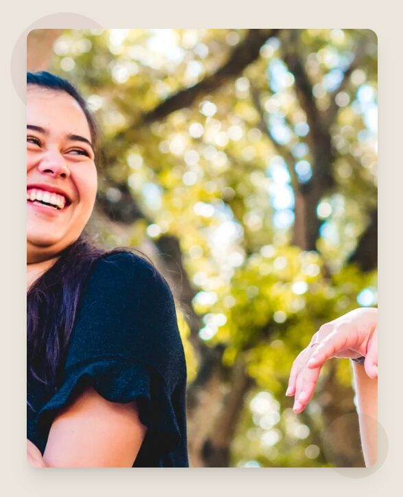 Joyful woman with blurred trees background
